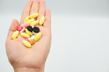 Colorful pills and medicines in the hand