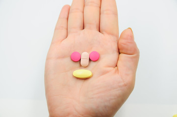 Colorful pills and medicines in the hand