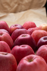 heap of unwashed unclean red apples mix on wooden background, top side view closeup