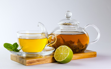 Glass cup and teapot of green tea