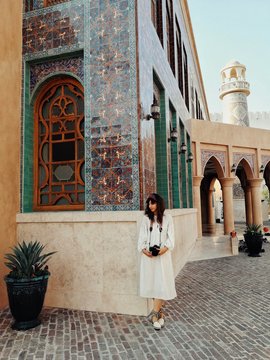 Woman standing in front of a mosque in Doha