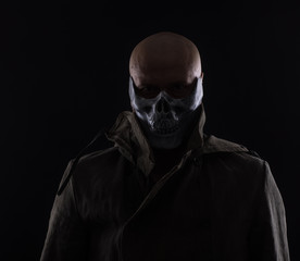 evil man in a scary mask on a black background