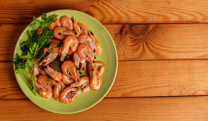 Shrimp and parsley on a red plate. The view from the top.
