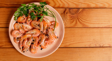 Shrimp and parsley on a red plate. The view from the top.