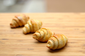Homemade rolled up pastry on a wooden table. Selective focus.