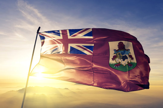 Bermuda Bermudian flag textile cloth fabric waving on the top sunrise mist fog