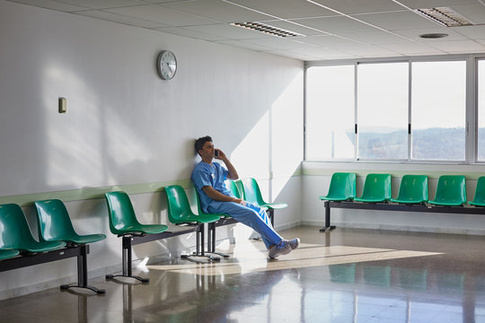 Doctor resting alone in a hospital waiting room.