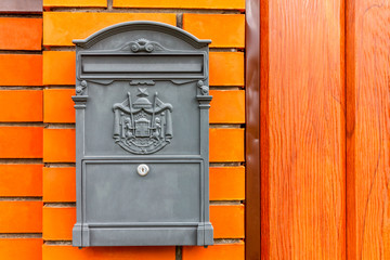 A beautiful mailbox hangs waiting for newspapers, parcels and letters.