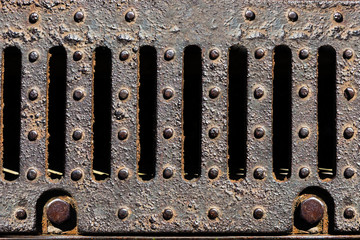 Rusty metal sewer grate close-up