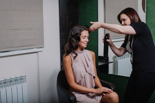 Hair Stylist At Work With Model At The Beauty Salon