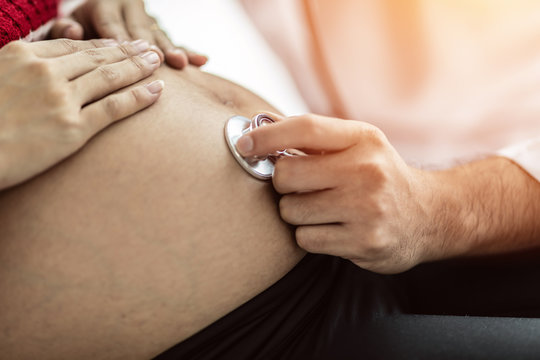 doctor using stethoscope for examining and diagnosis pregnant woman in Pregnancy hospital or clinic,Medical Pregnancy exam concept,Selective Focus