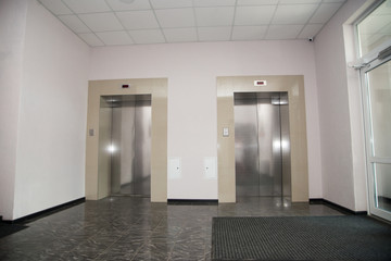 Two doors of elevators in modern business building.