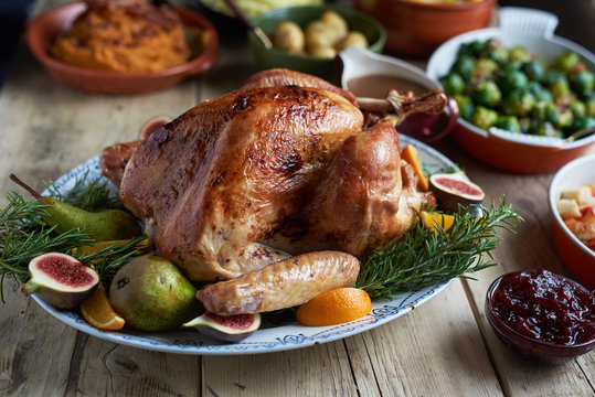 Turkey dinner and side dishes on a wood background.