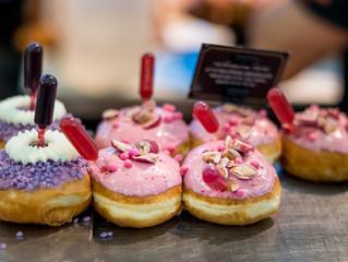 Fresh donuts at bakery display for Hanukkah celebration. Selective focus.