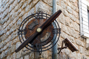 Fototapeta na wymiar Old, rusty vintage clock on the corner of the house.