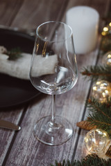 Wooden Table with Christmas decorations and garland, ware, green spruce branches