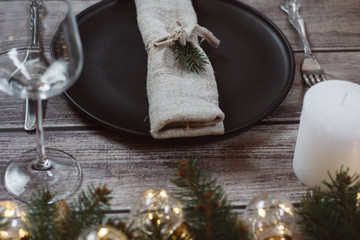 Wooden Table with Christmas decorations and garland, ware, green spruce branches