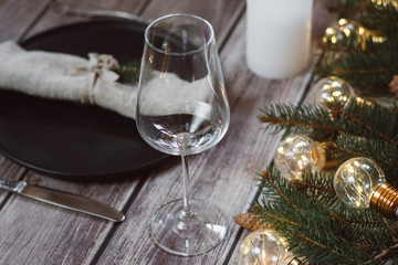 Wooden Table with Christmas decorations and garland, ware, green spruce branches