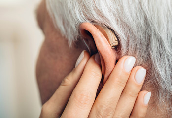 adjusting of a hearing aid for an aged man
