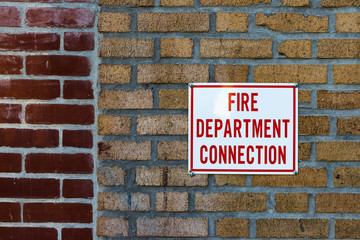 Fire department conection sign on brick wall background