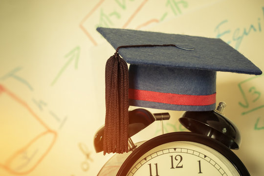 Graduation cap on top retro alarm clock with math formula equation graph on screen classroom. Ideas for abroad international Educational and times Studies lead to success in life, Back to School