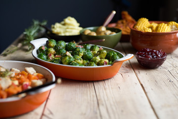 Turkey dinner and side dishes on a wood background.