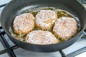 Minced cutlets are fried in a pan in boiling oil.