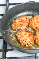 Minced cutlets are fried in a pan in boiling oil.