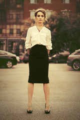 Young fashion business woman in white shirt walking in city street