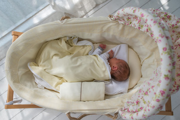 Baby sleeping in vintage crib, top view