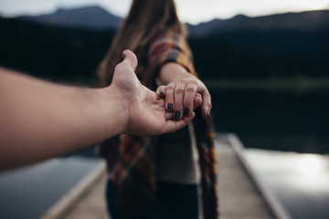 Young woman enjoying at lake on autumn day.