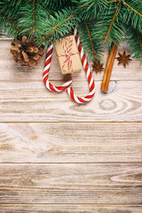 Christmas gift, candy canes and snowflakes on a wooden rustic vintage background