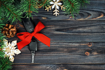 Close-up view of car keys with red bow as present on wooden vintage background