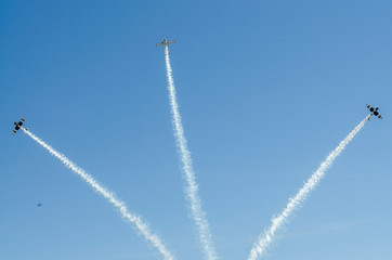 Planes in the blue sky and their white traces