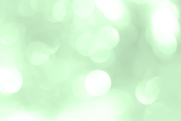 Shiny green New Year background for holiday card. A wallpaper with a blurry pattern.