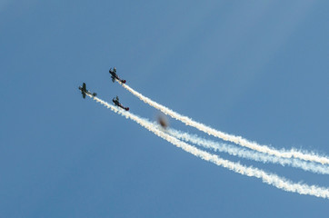 Planes in the blue sky and their white traces