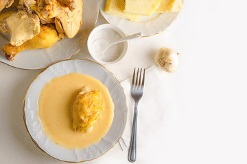 Caucasian cuisine. Circassian (Adyghe) traditional folk dish. Boiled chicken with sour cream sauce (djedlibje) Served with pasta (millet dish). Place for text