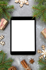 Digital tablet mock up with rustic Christmas gray cement background decorations for app presentation. top view with copy space