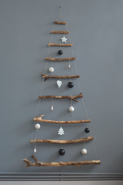 Minimal handmade Christmas tree by the wall indoor