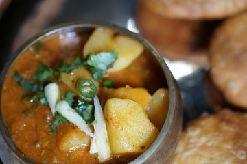 Spicy and tangy Aalu or potato sabji or curry served with Khasta