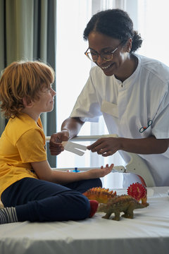Doctor female giving attention and care to child in a hospital room