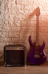 Guitar and amplifier on a stone background
