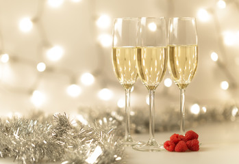 Three glasses of Christmas champagne with bokeh