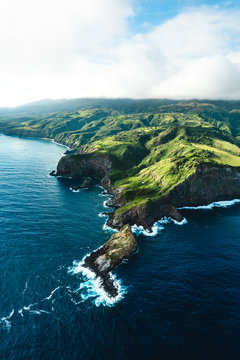 Beautiful Aerial View of Tropical Island Paradise Nature Scene of Maui Hawaii On Clear Sunshine Blue Sky Day with Vibrant Blue Ocean Water and Waves and Lush Green Mountain Scenic Landscape © Lucas