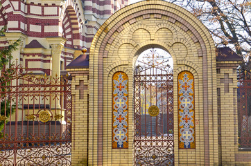 Entrance to the church. Arch with a religious decor. Christian religion