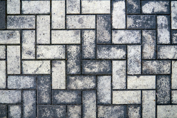 Obraz premium top view of a dirty gray brick pavement