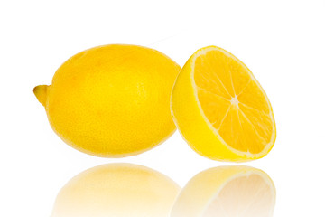 Fresh lemon with half isolated on white with mirror reflection on surface