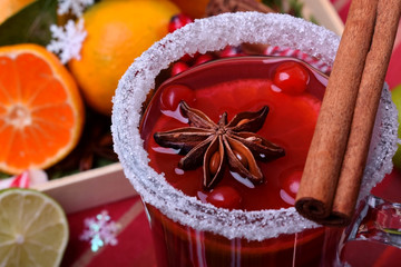 Hot mulled wine with slices of citrus fruits, cinnamon and anise in an Irish glass decorated with sugar border