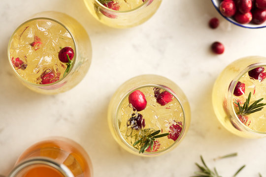 Top view of iced mocktails with cranberry and rosemary.