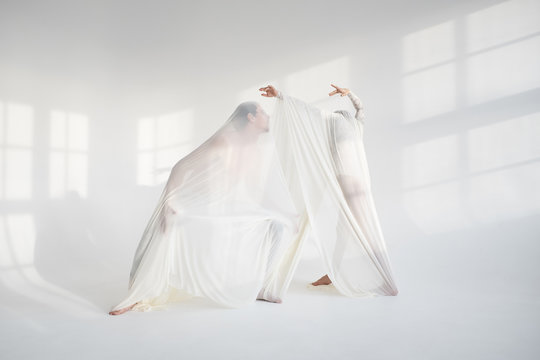 Couple dancing under fabric